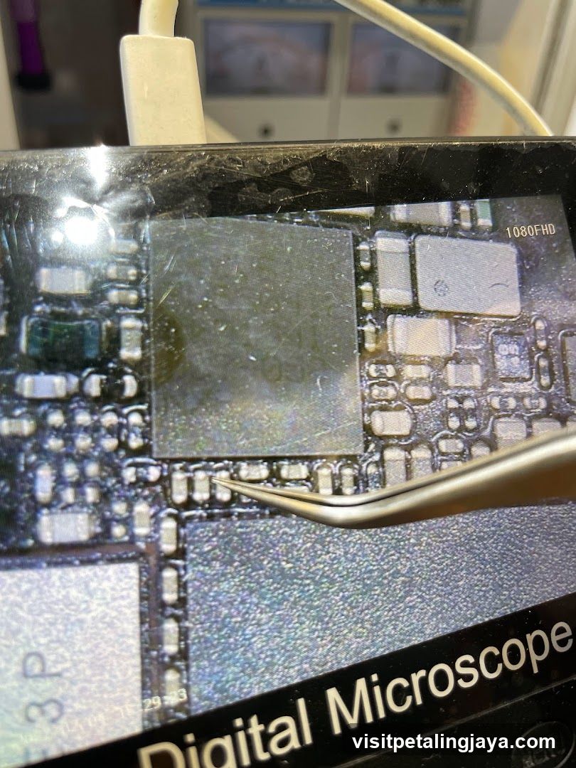 Close-up of a circuit board under a digital microscope