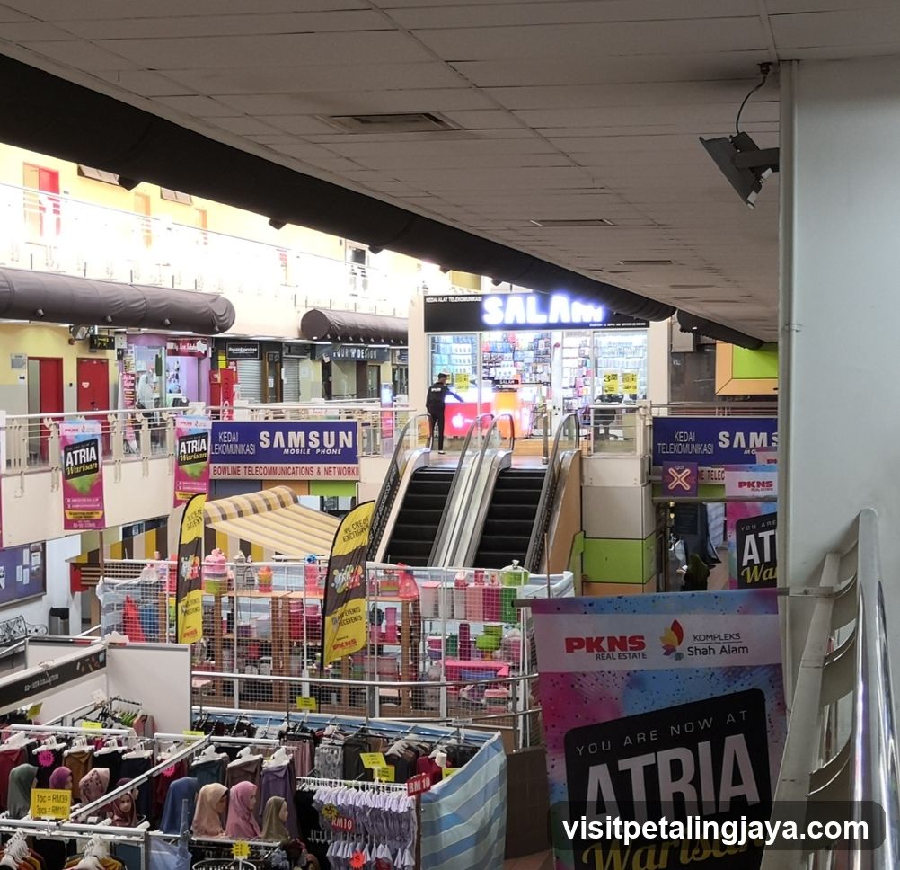 Indoor shopping mall with various shops and escalators