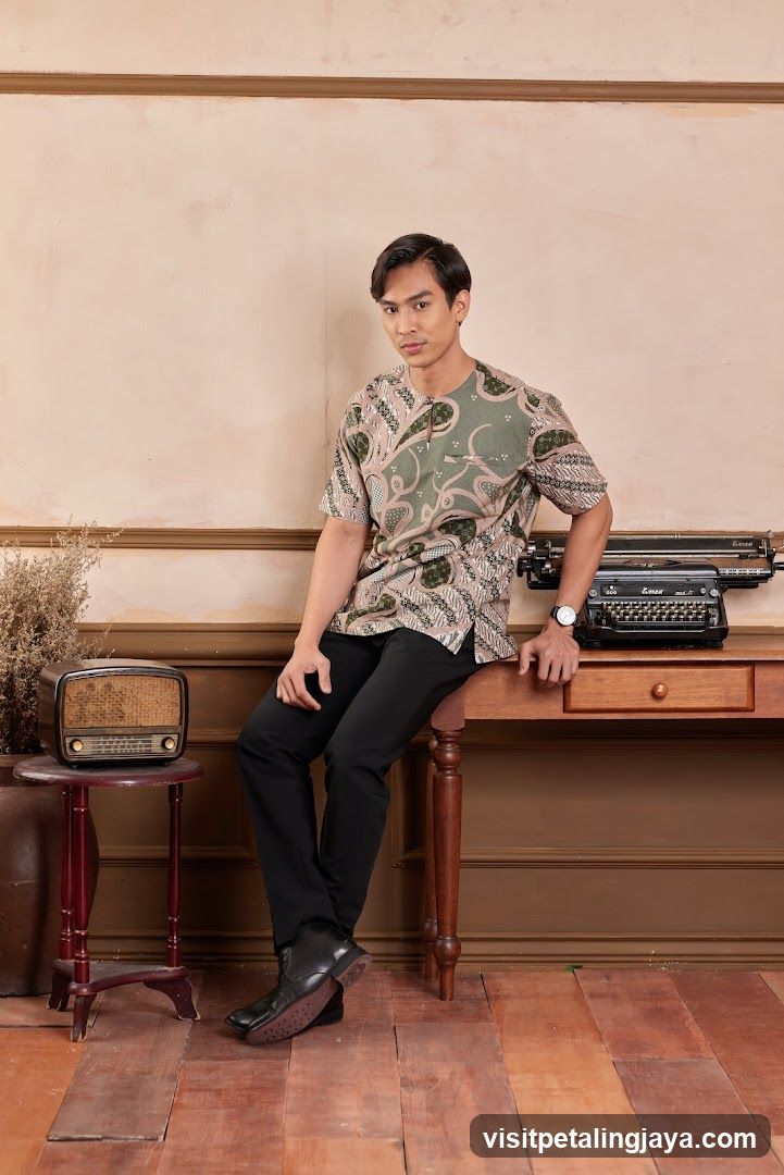 Man in Batik Shirt Posed by Desk