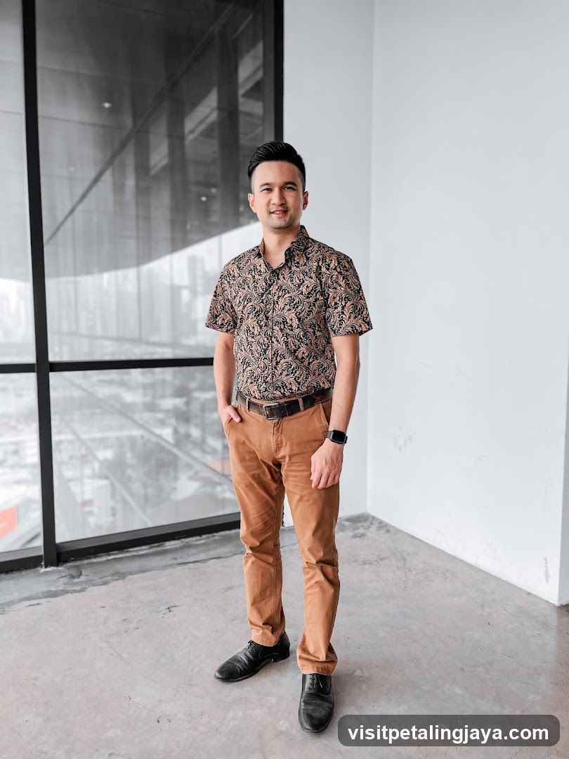 Man in patterned shirt and brown pants