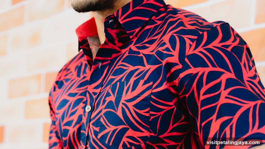 Man Wearing a Red and Blue Leaf-Patterned Shirt
