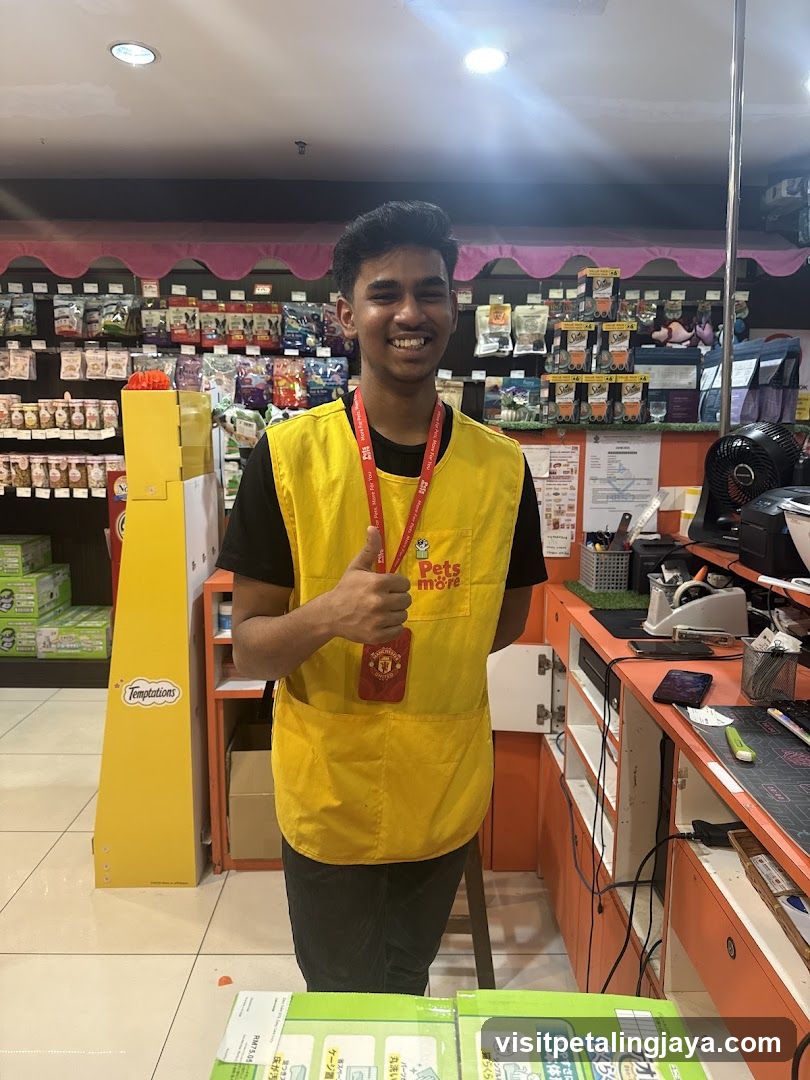 Employee giving a thumbs up in a pet store