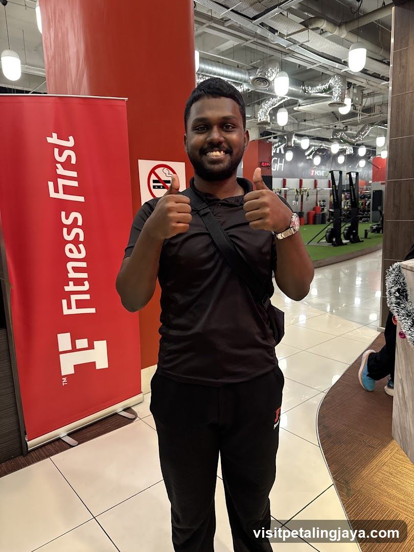 Man giving thumbs up in gym