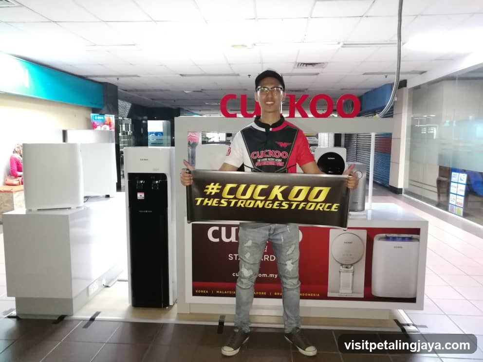 Man holding Cuckoo banner