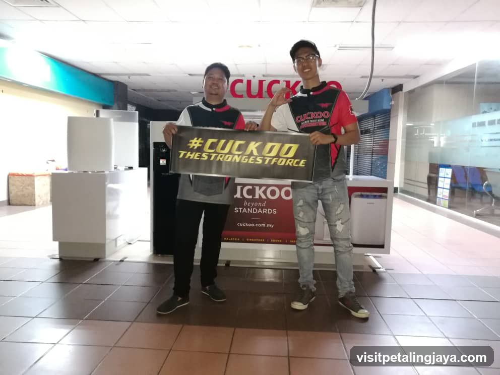 Two men holding a CUCKOO sign