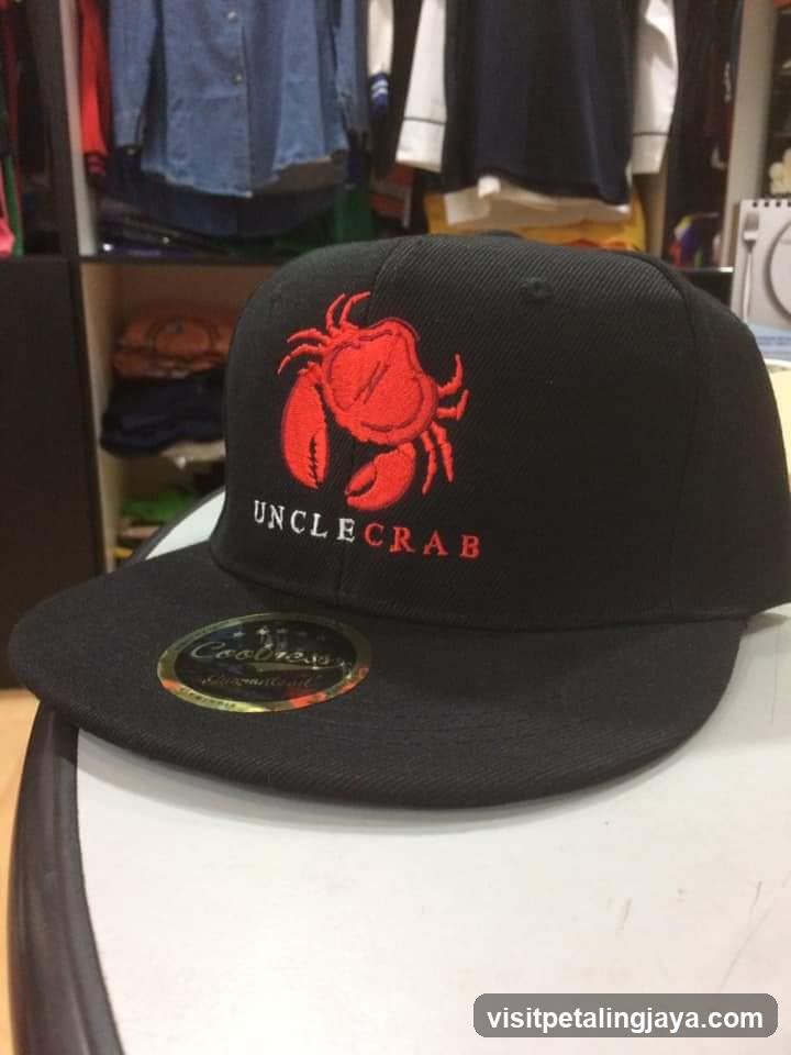Black baseball cap with red crab logo