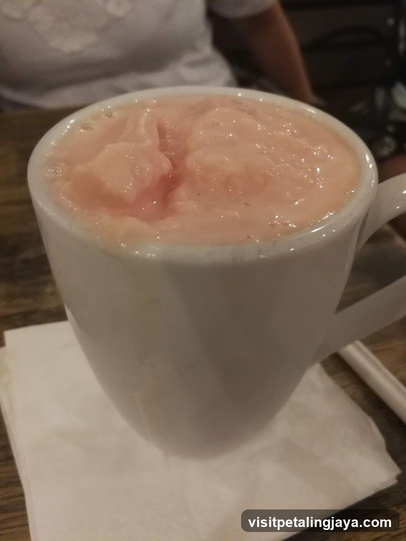Pink Frothy Drink in a White Mug