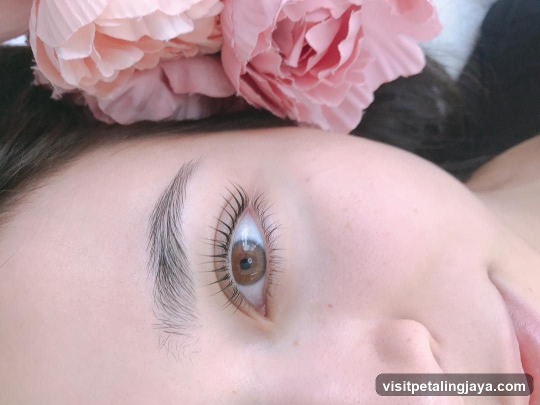 Close-up of a woman's eye with a pink flower accessory