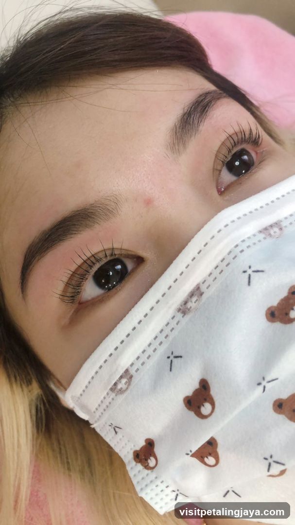 Close-up of a woman's eyes and face with a mask
