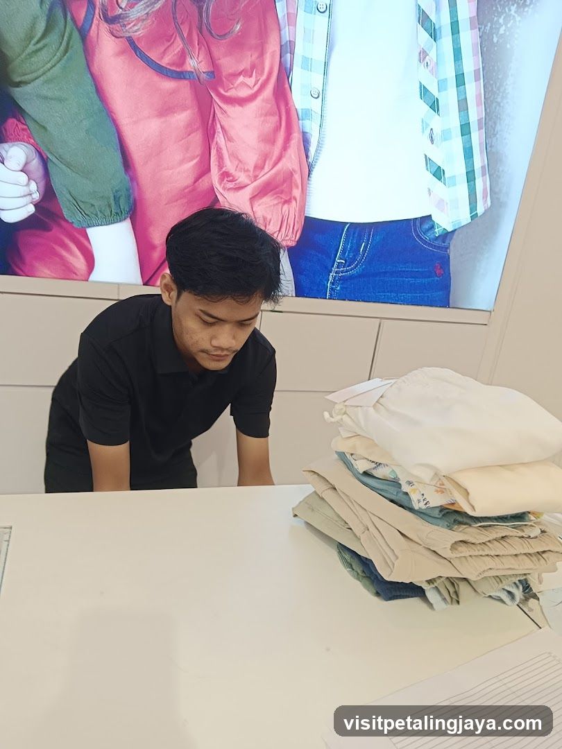 Store employee folding clothes