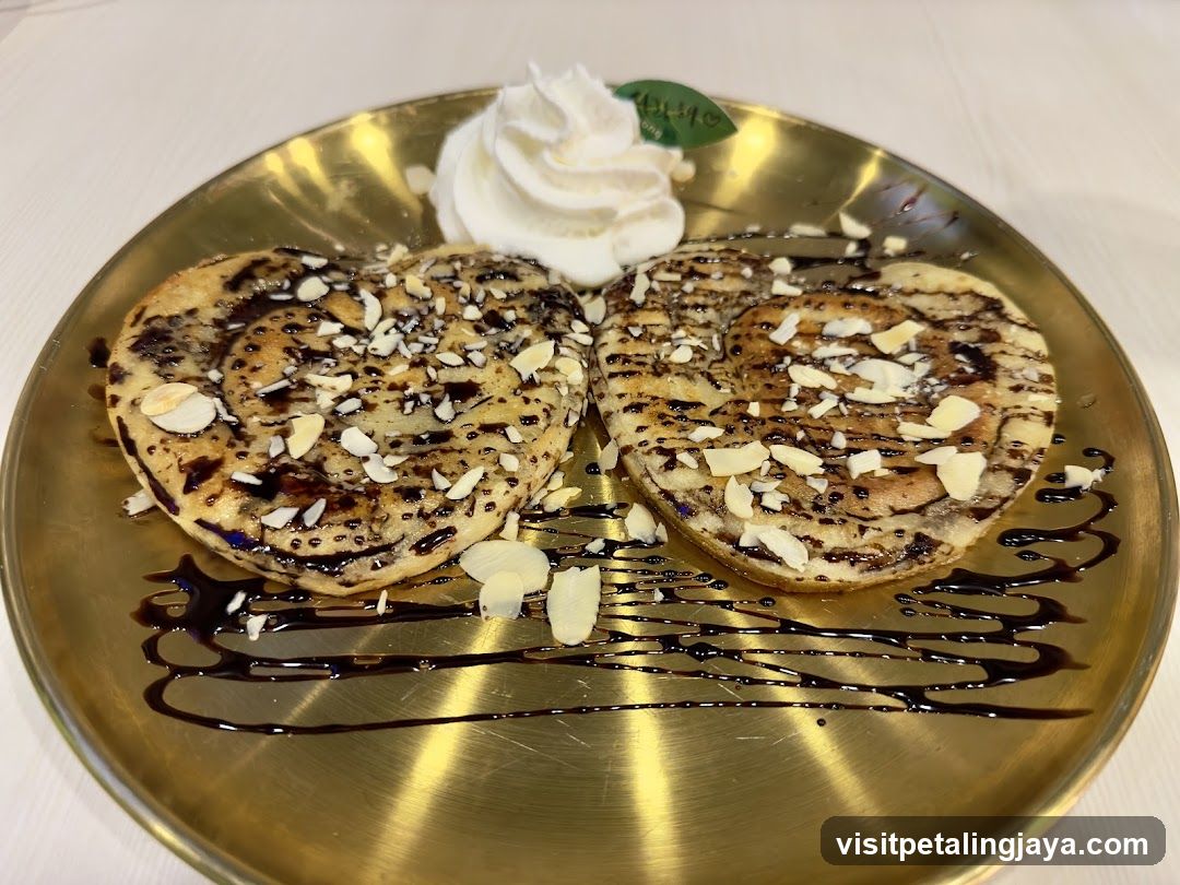 Heart-shaped pancakes with chocolate and almonds