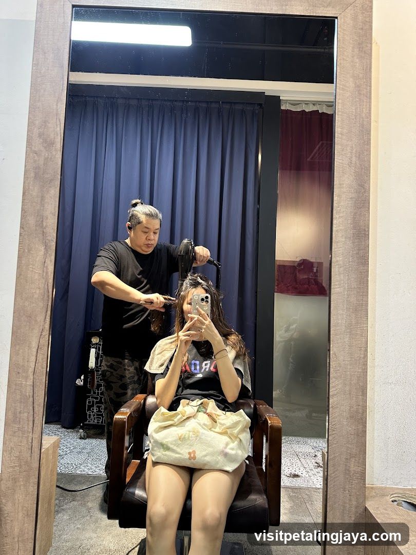 Hairdresser drying client's hair