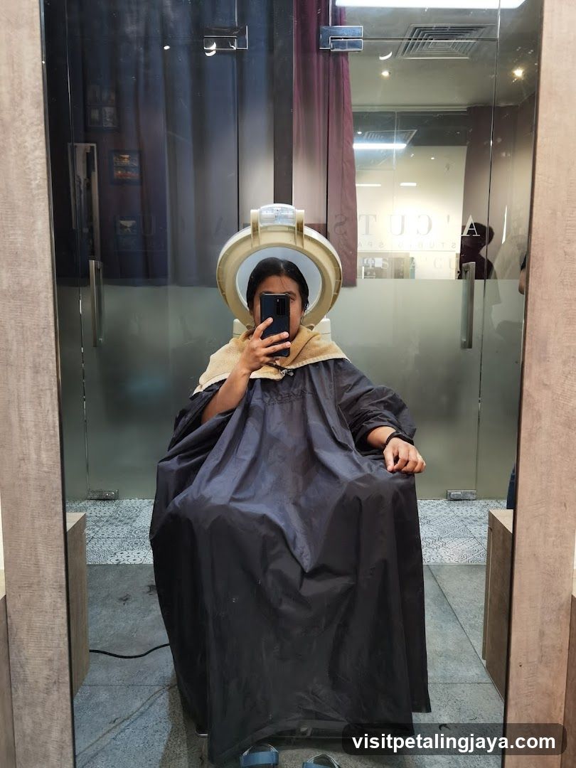 Woman under hair steamer