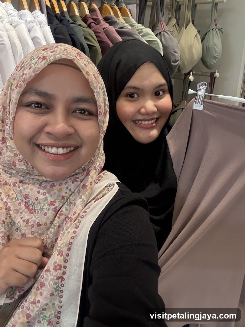 Two women smiling in a clothing store