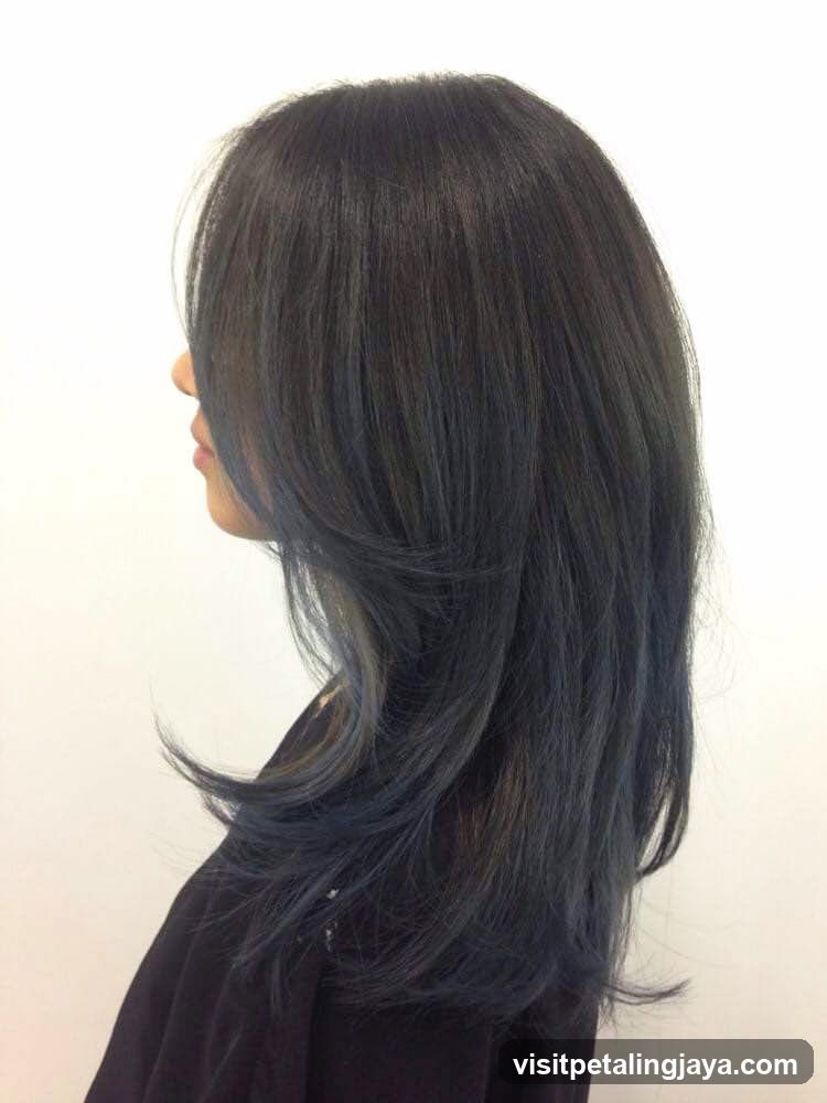 Woman with dark hair with blue highlights