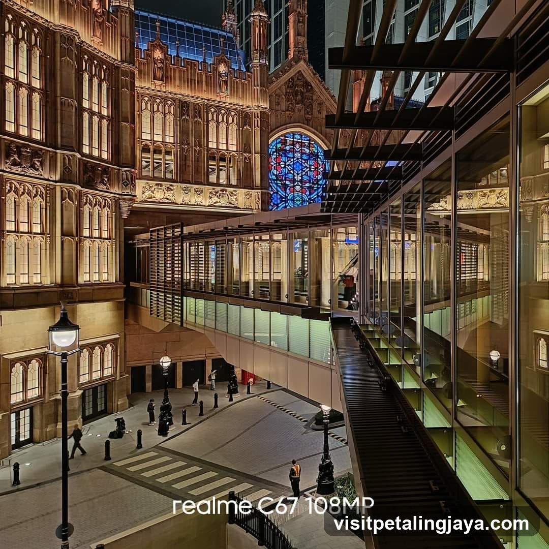 Night view of a modern building with a stained glass window and a skywalk