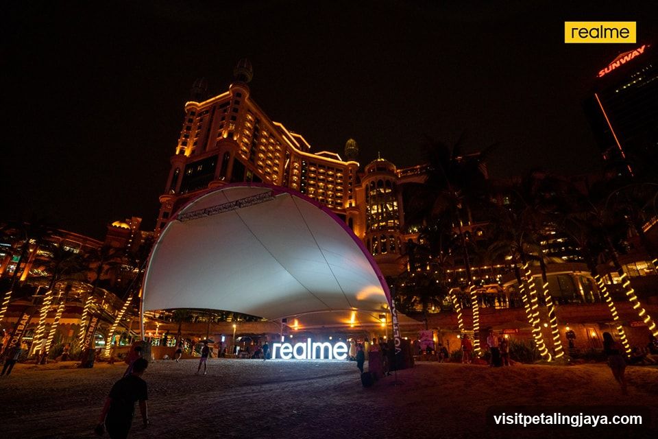 Outdoor event at night with illuminated building and signage