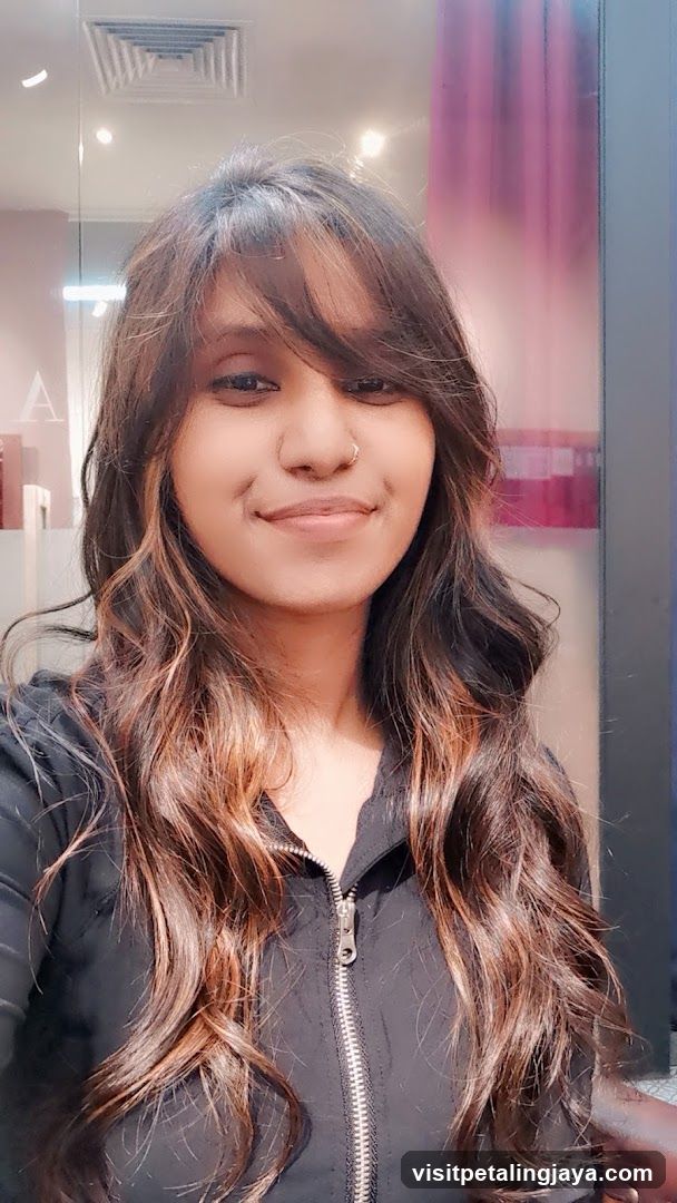Woman with long, wavy, highlighted hair