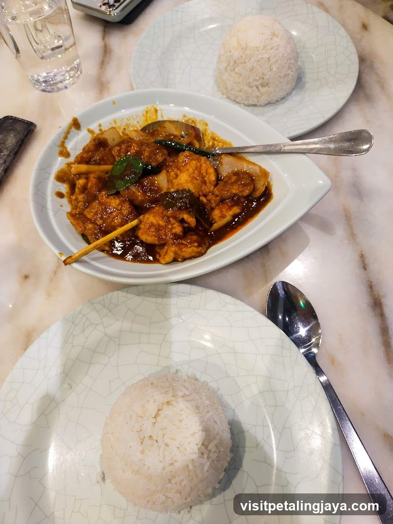 Two servings of rice with a dish of chicken and vegetables