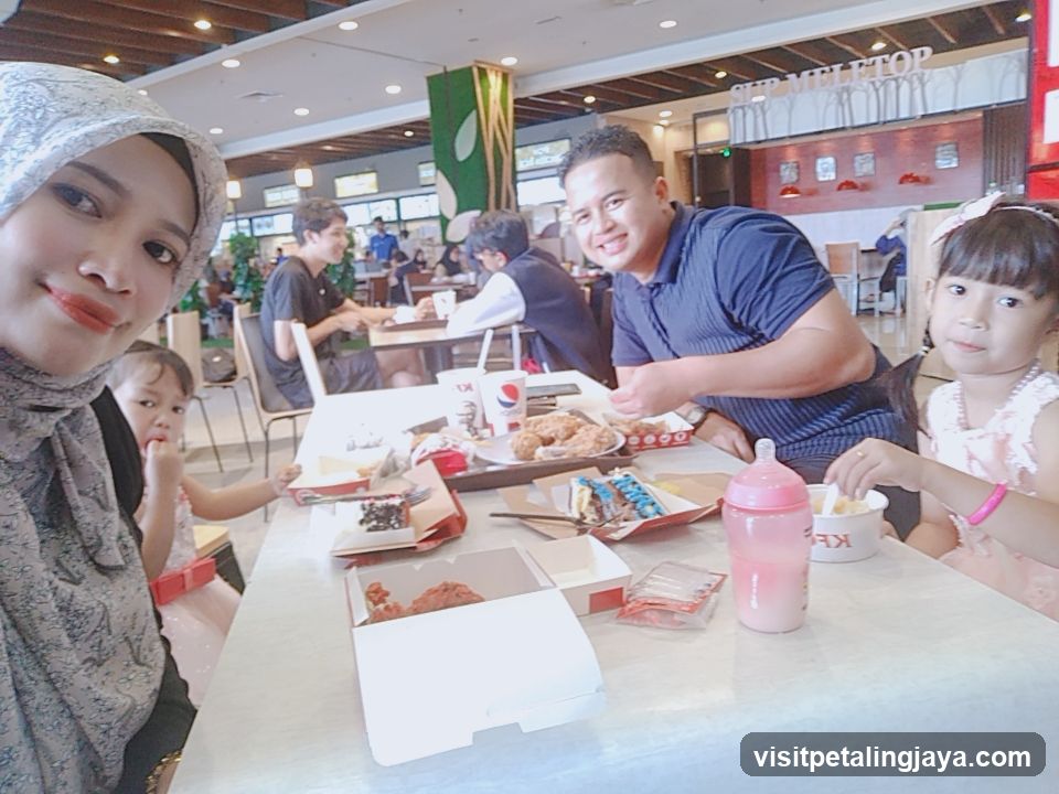 Family enjoying a meal at a food court