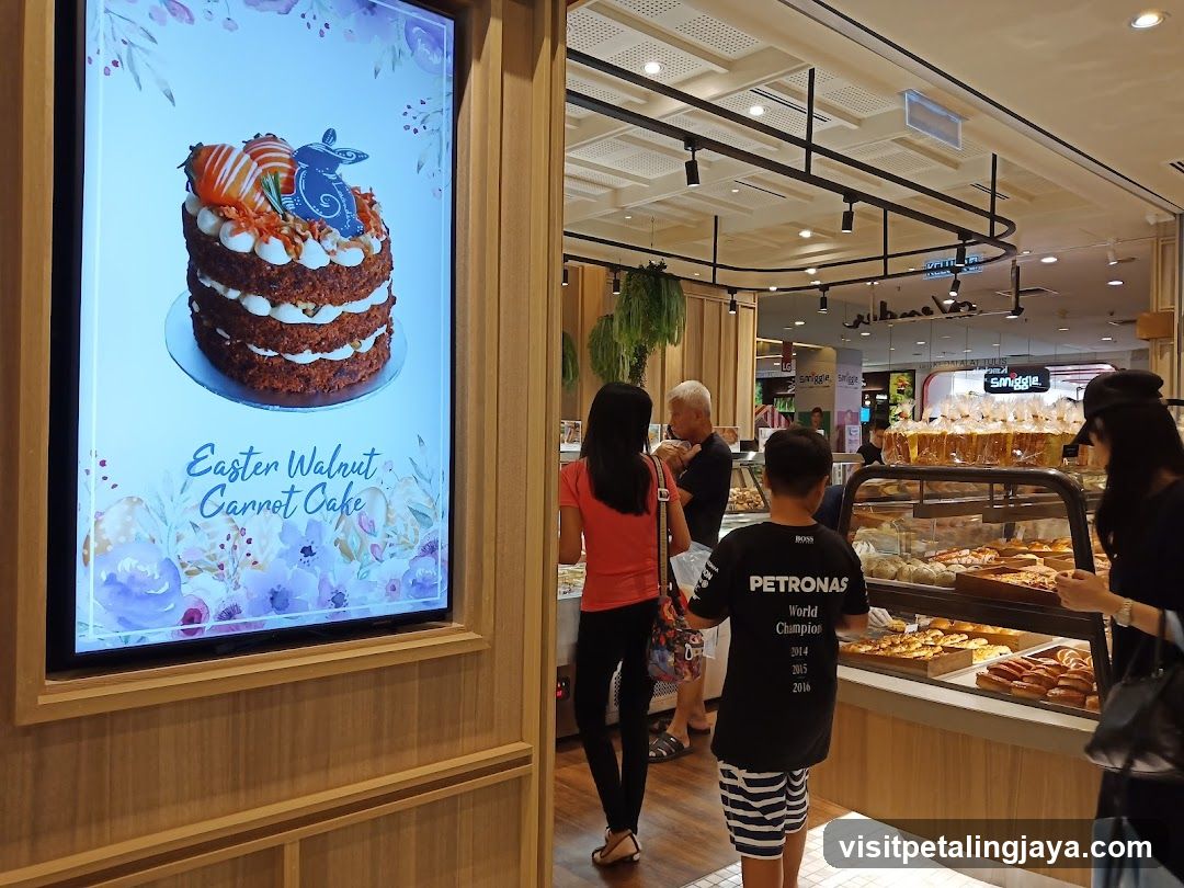 Bakery Display with Easter Cake Advertisement