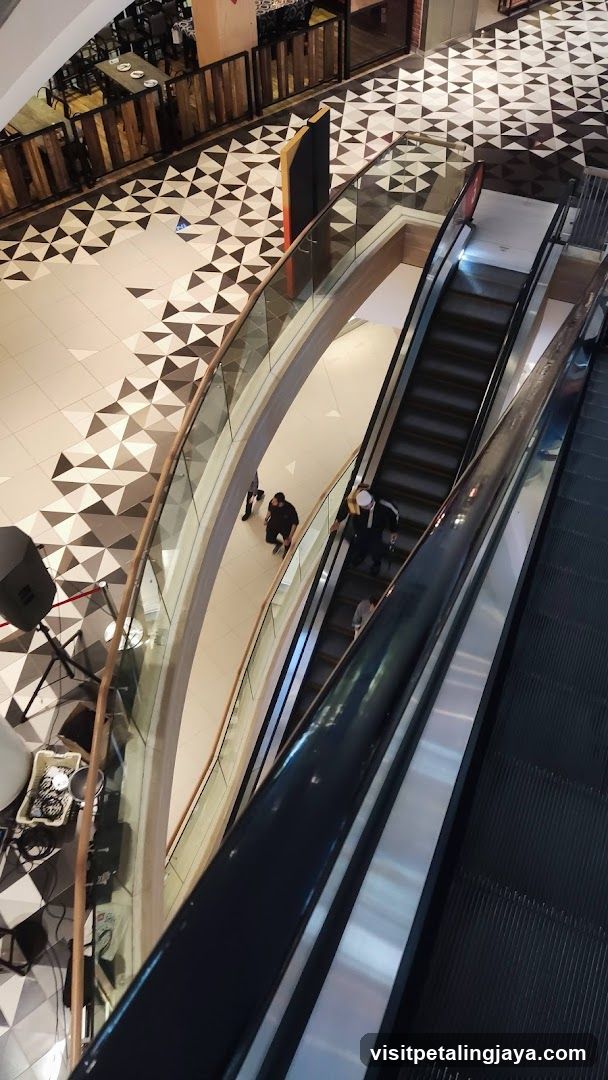 Mall Interior with Escalators and Geometric Flooring