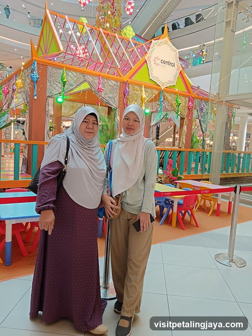Two Women Posing in Front of a Festive Display