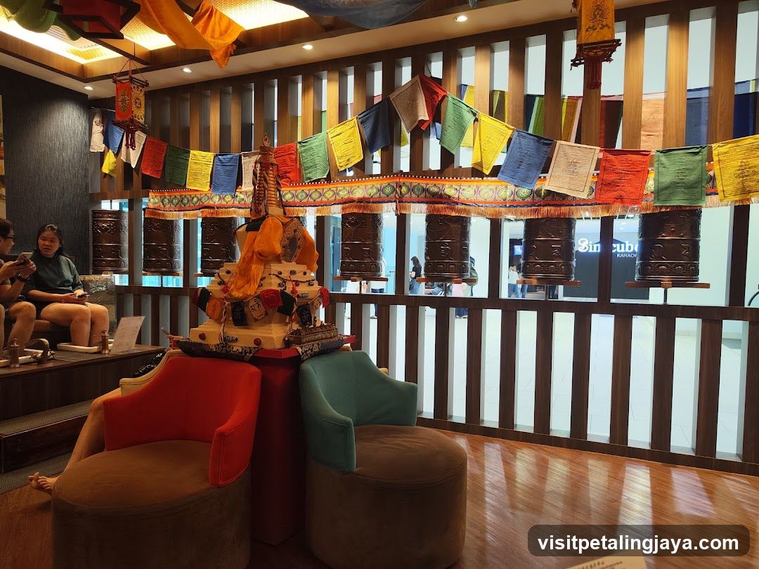 Tibetan-themed waiting area with prayer wheels and flags
