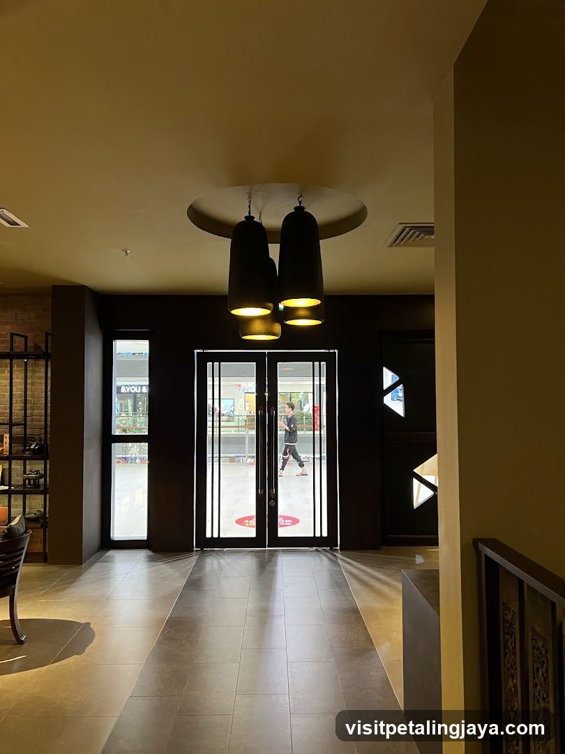 Interior view of a walkway leading to glass doors