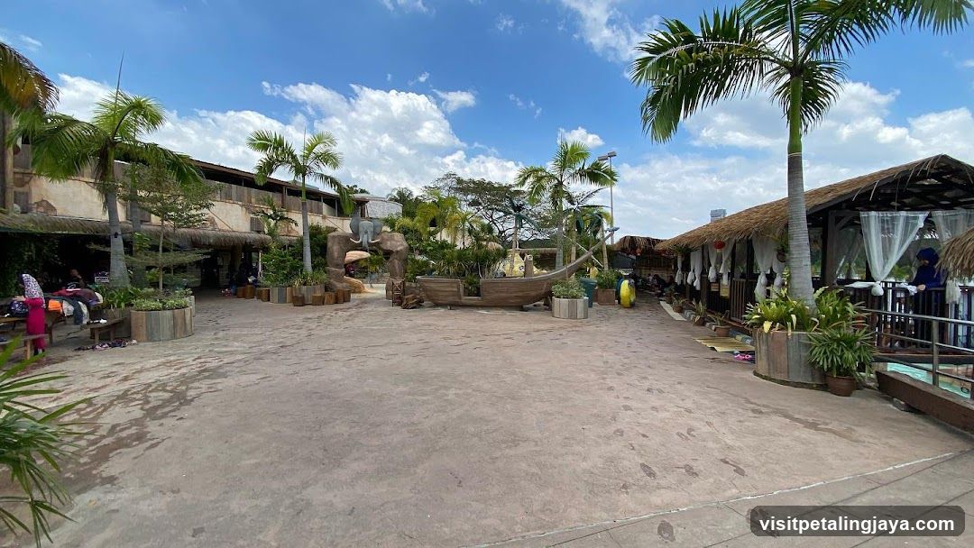 Water park with thatched-roof cabanas and tropical landscaping