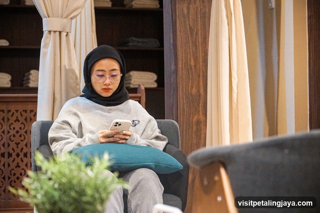 Woman using phone in a lounge area