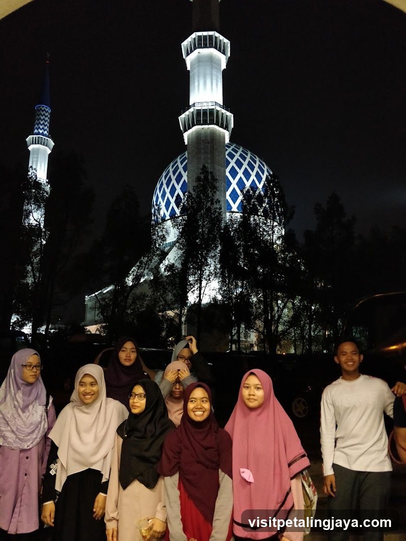 Group of people in front of a mosque at night