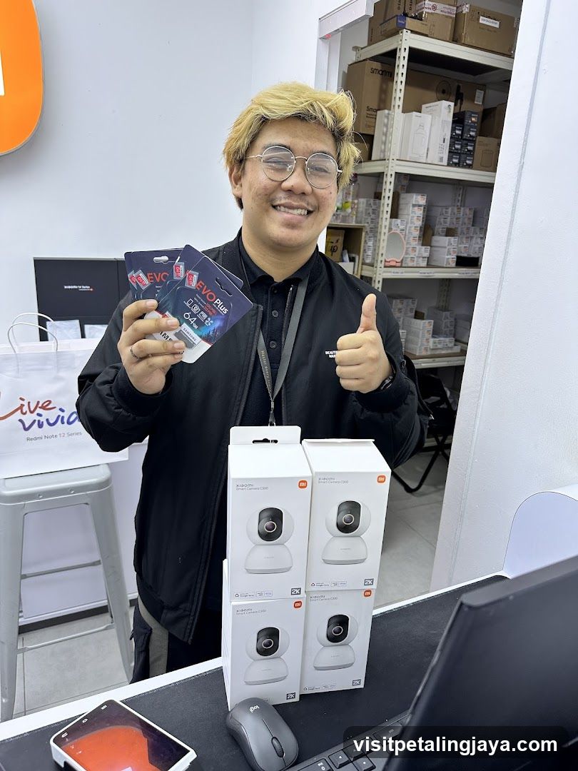 Man holding memory cards and showing Xiaomi smart cameras