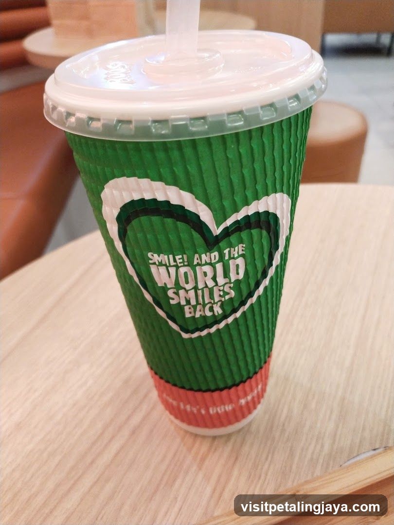 Green cup with a heart logo and text