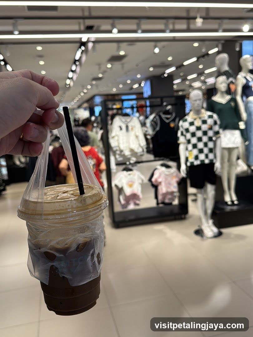 Person holding a coffee in a store