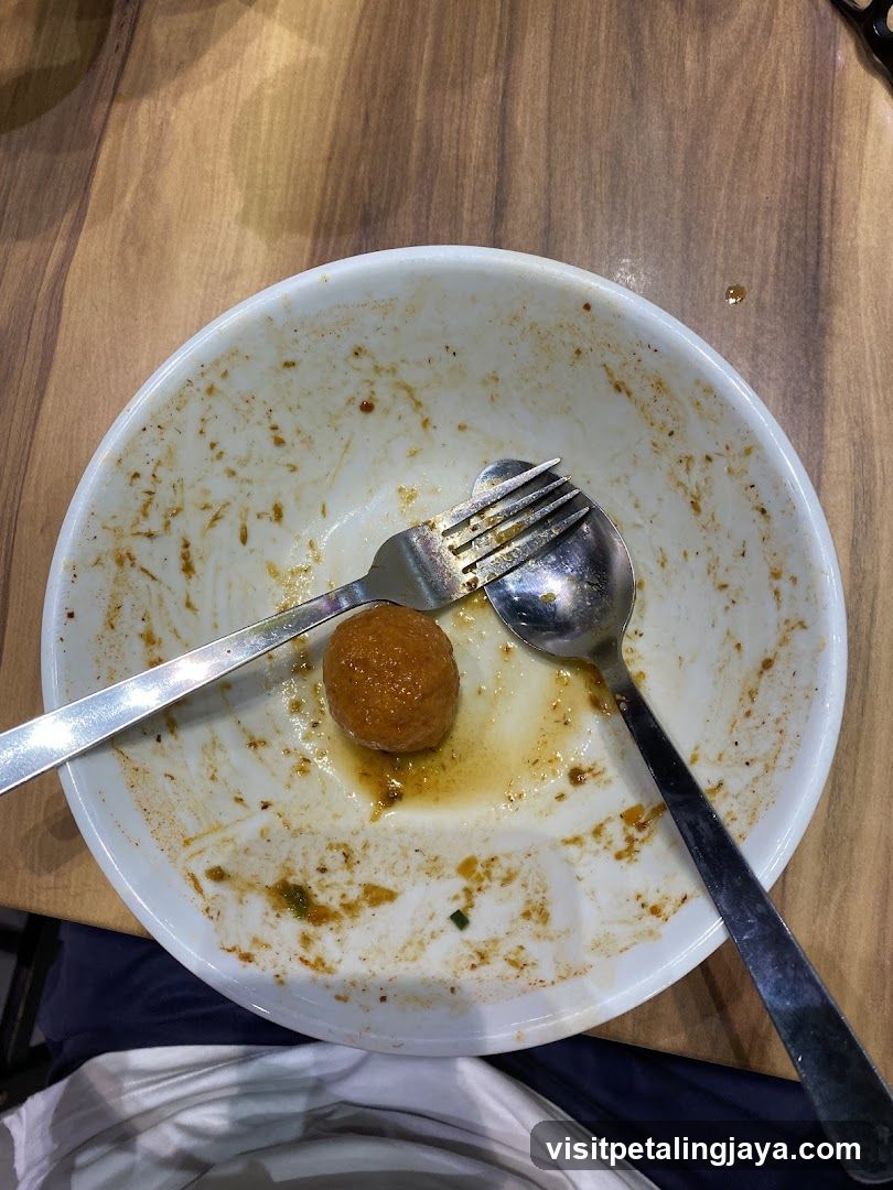 Dirty Bowl with Meatball and Utensils