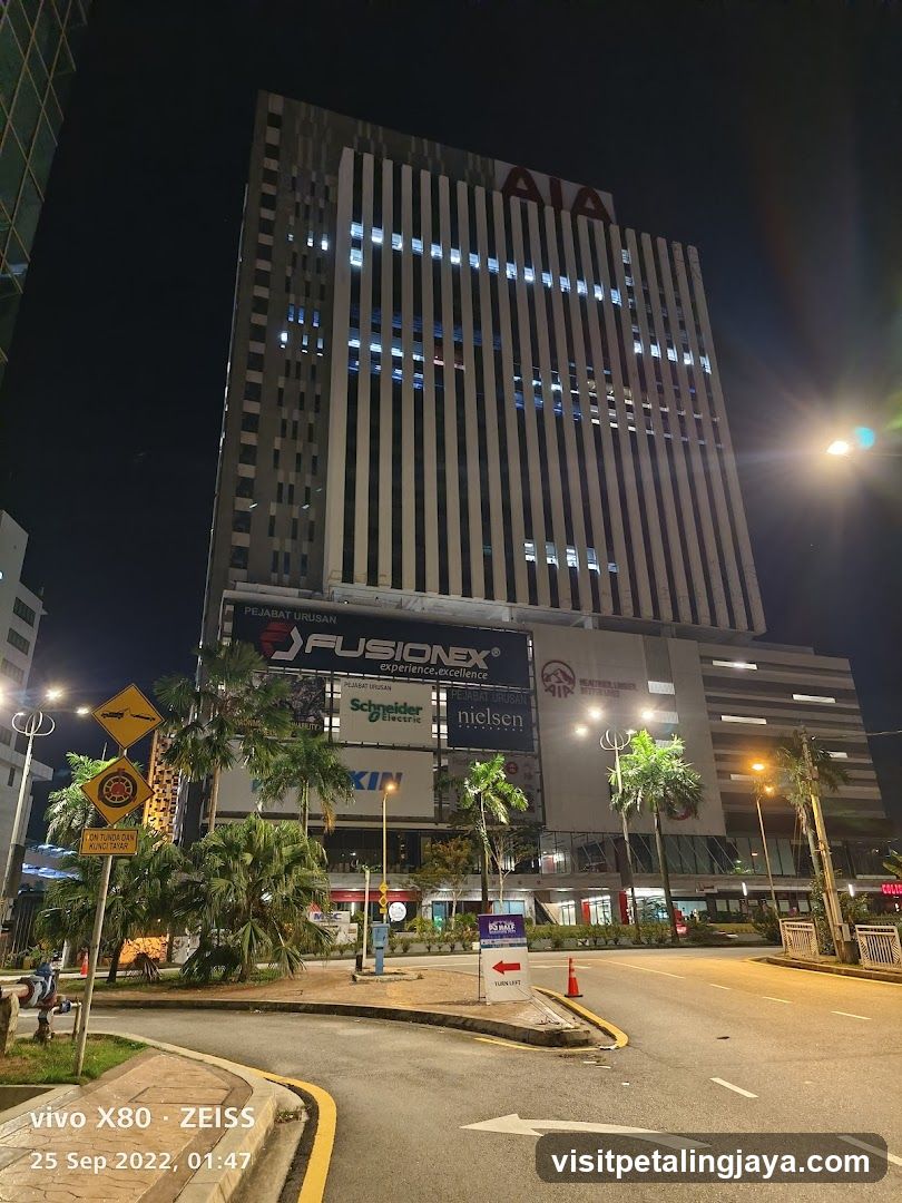 Night view of a modern office building with signage