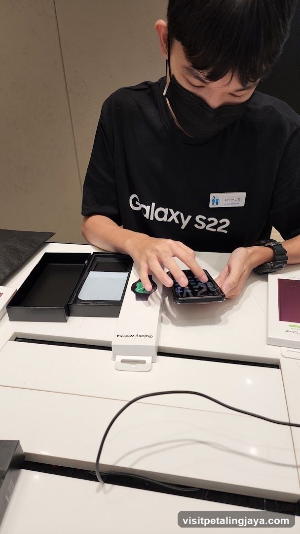 Retail assistant demonstrating a smartphone