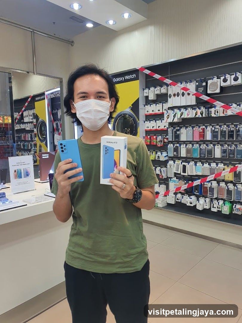 Man holding a new phone and box