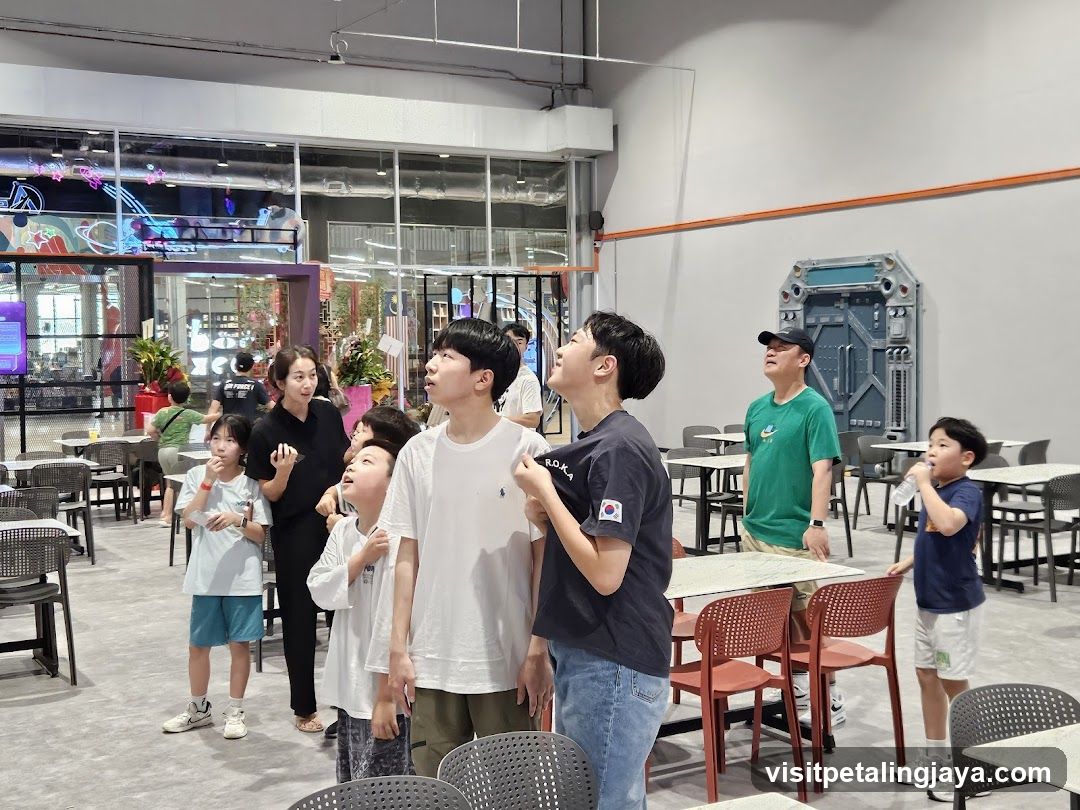 People looking up in a large indoor space