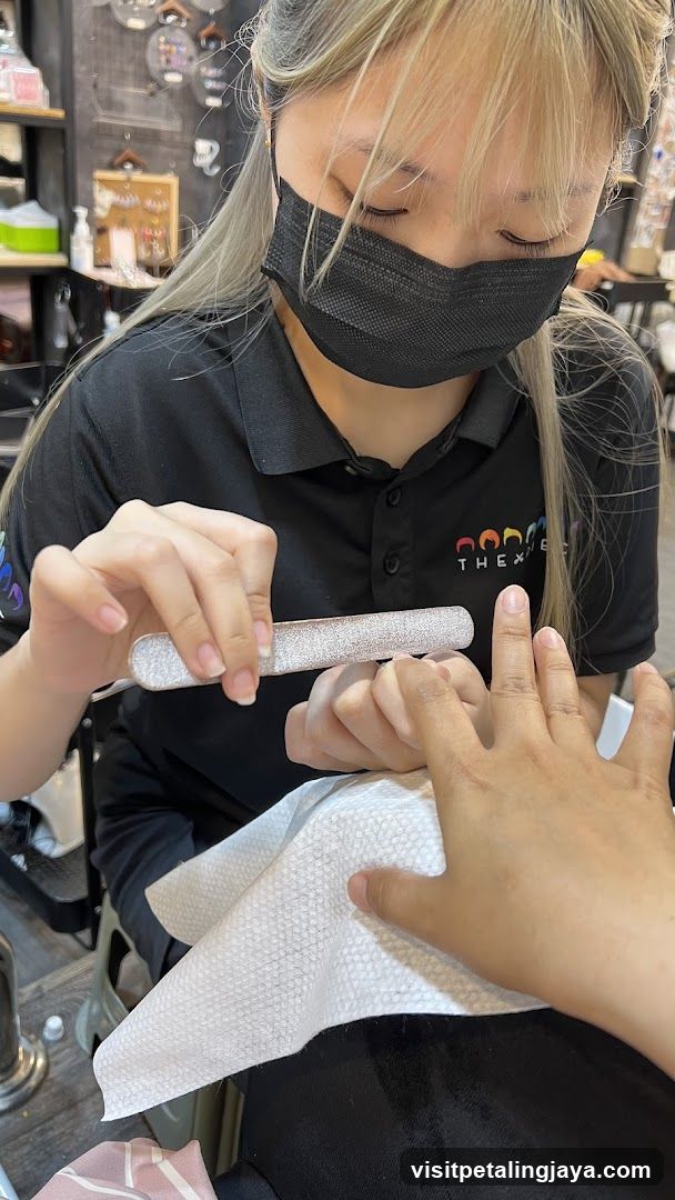 Nail Technician Filing Client's Nails