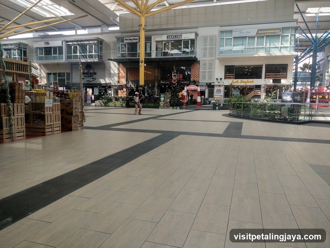 Outdoor shopping mall with various storefronts and displays