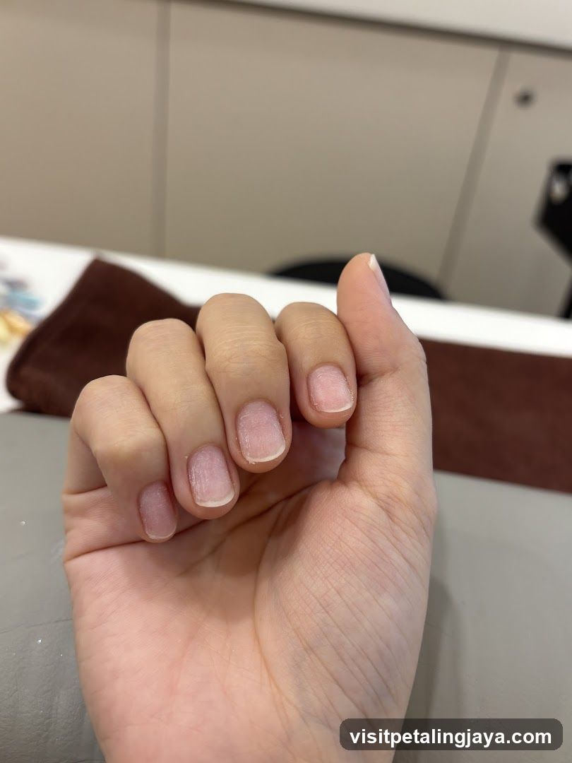 Close-up of a hand with unpolished nails