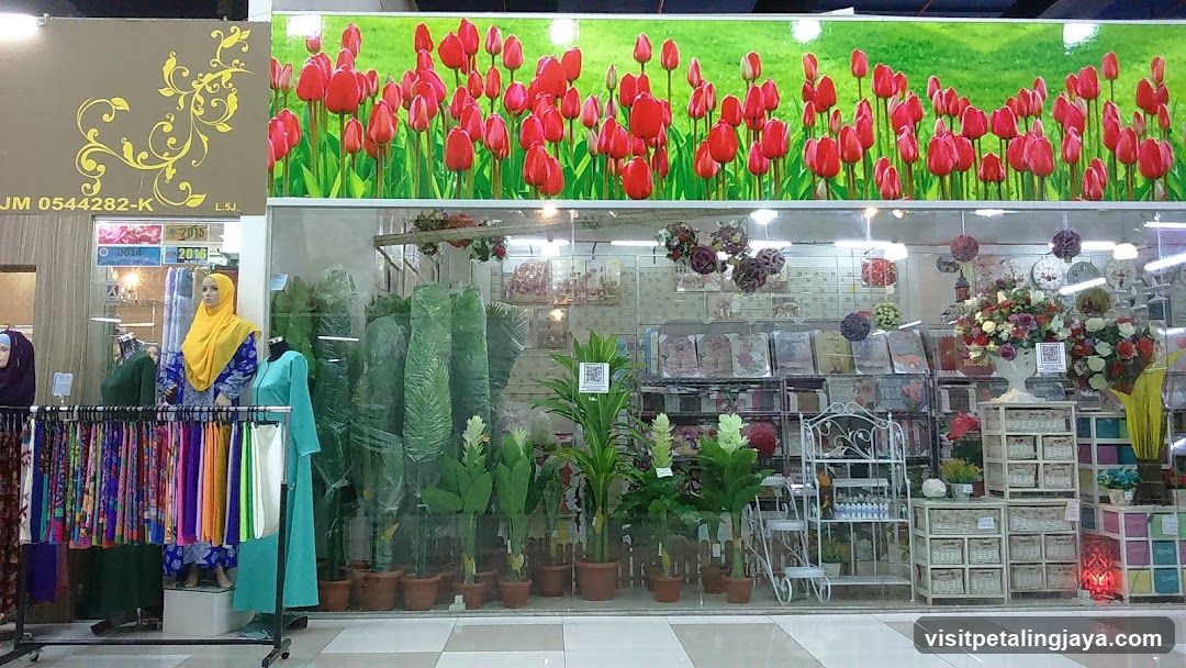Storefront with floral decorations and clothing displays