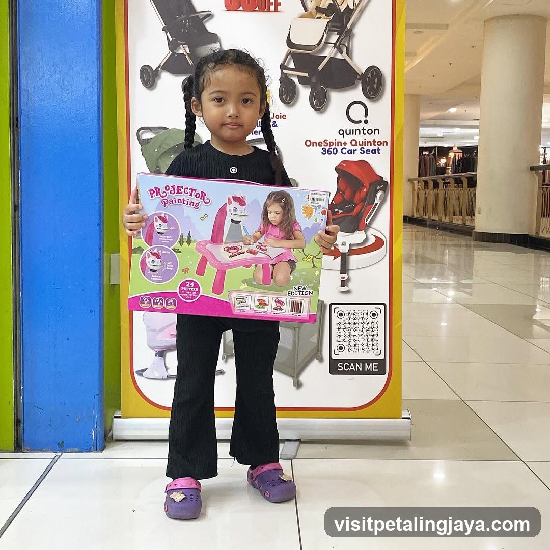 Child Holding a Toy Projector Painting Set