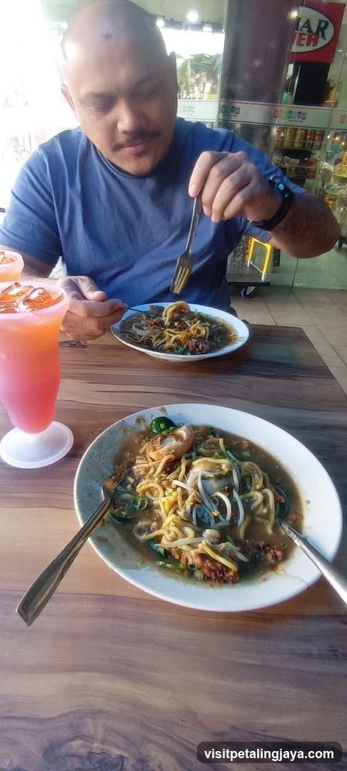 Man eating noodles at a restaurant