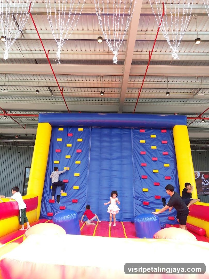 Children on inflatable climbing wall