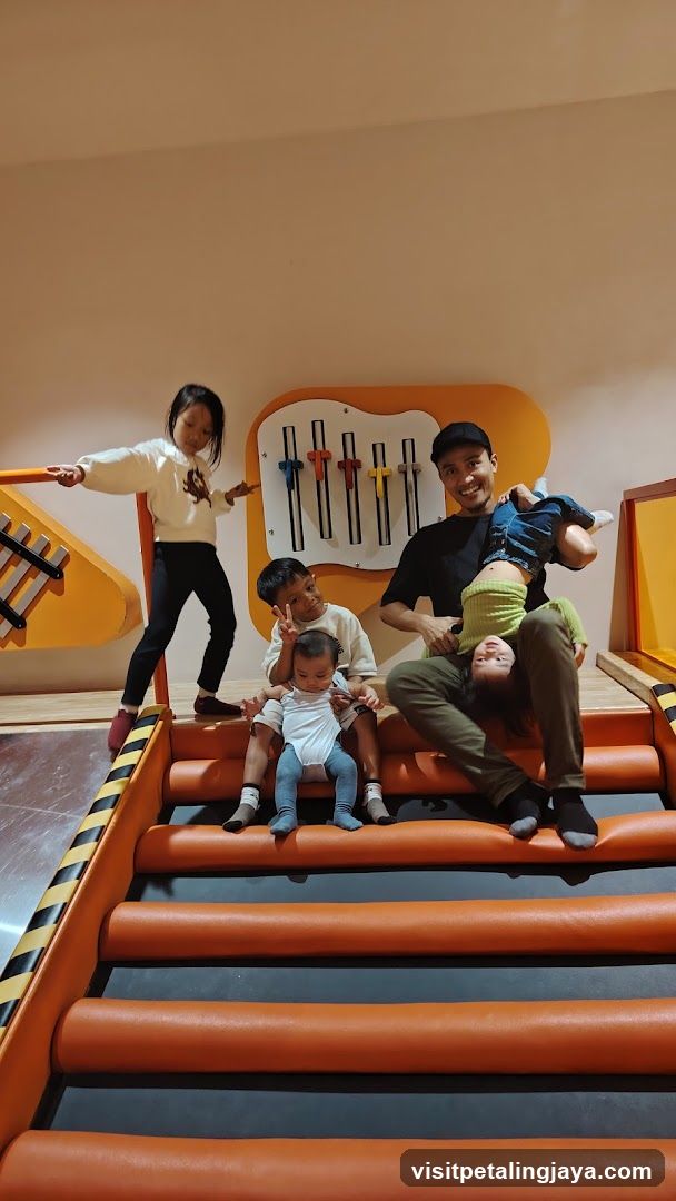 Family playing in a colorful indoor playground