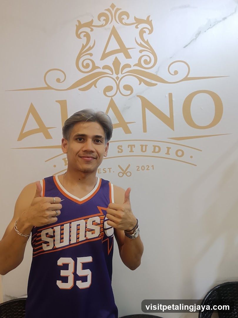 Man in Suns Jersey Posing in Front of Studio Logo