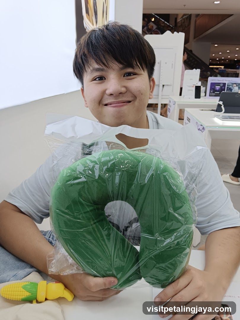 Person holding green neck pillow in store interior